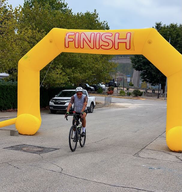 Anthony Brown riding through the finish arch at the Limestone Cycling Tour