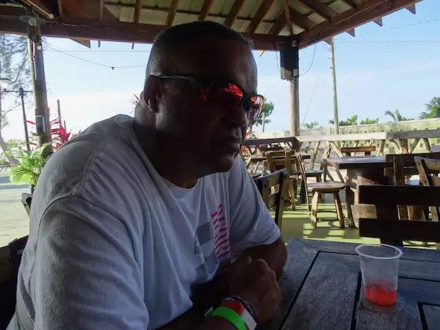 Anthony Brown sitting at an open-air table on the Jamaica trip